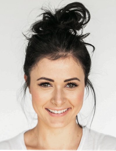 Orla, the primary persona for Vstage: a smiling woman in her late twenties.